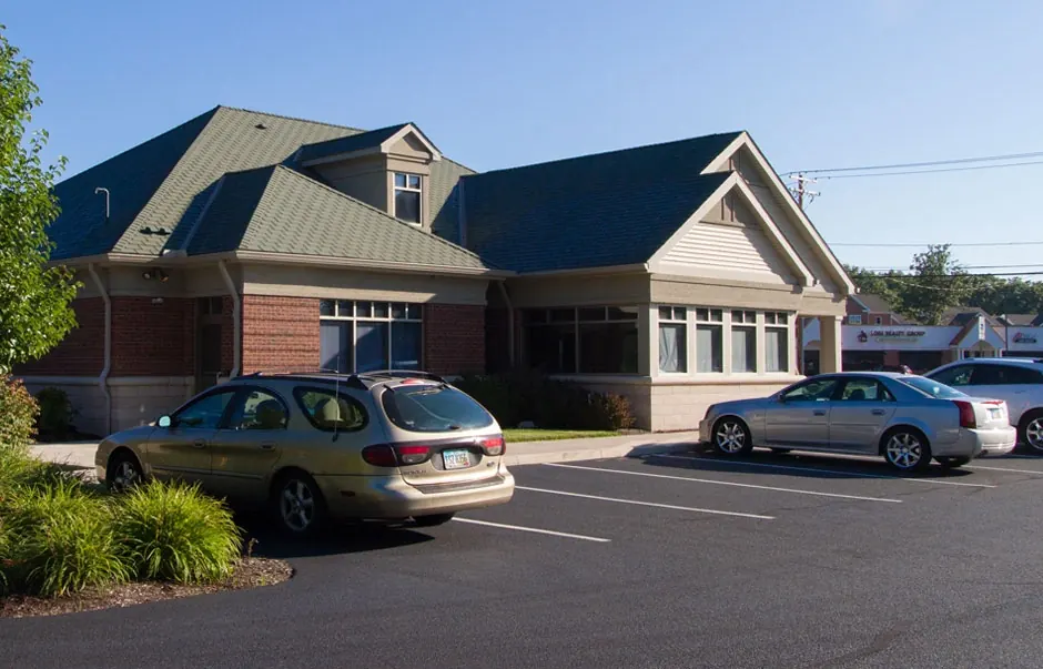 The side of the building and the car park, with spaces close to the door.